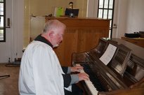 a priest playing the piano
